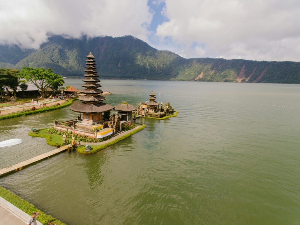 A stunning aerial view of Pura Ulun Danu Bratan Temple situated by a serene lake in the highlands of Bali, Indonesia.